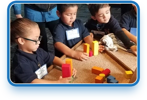 child playing a game inside kids first learning center in los angeles county, highlighting our preschool educational programs.